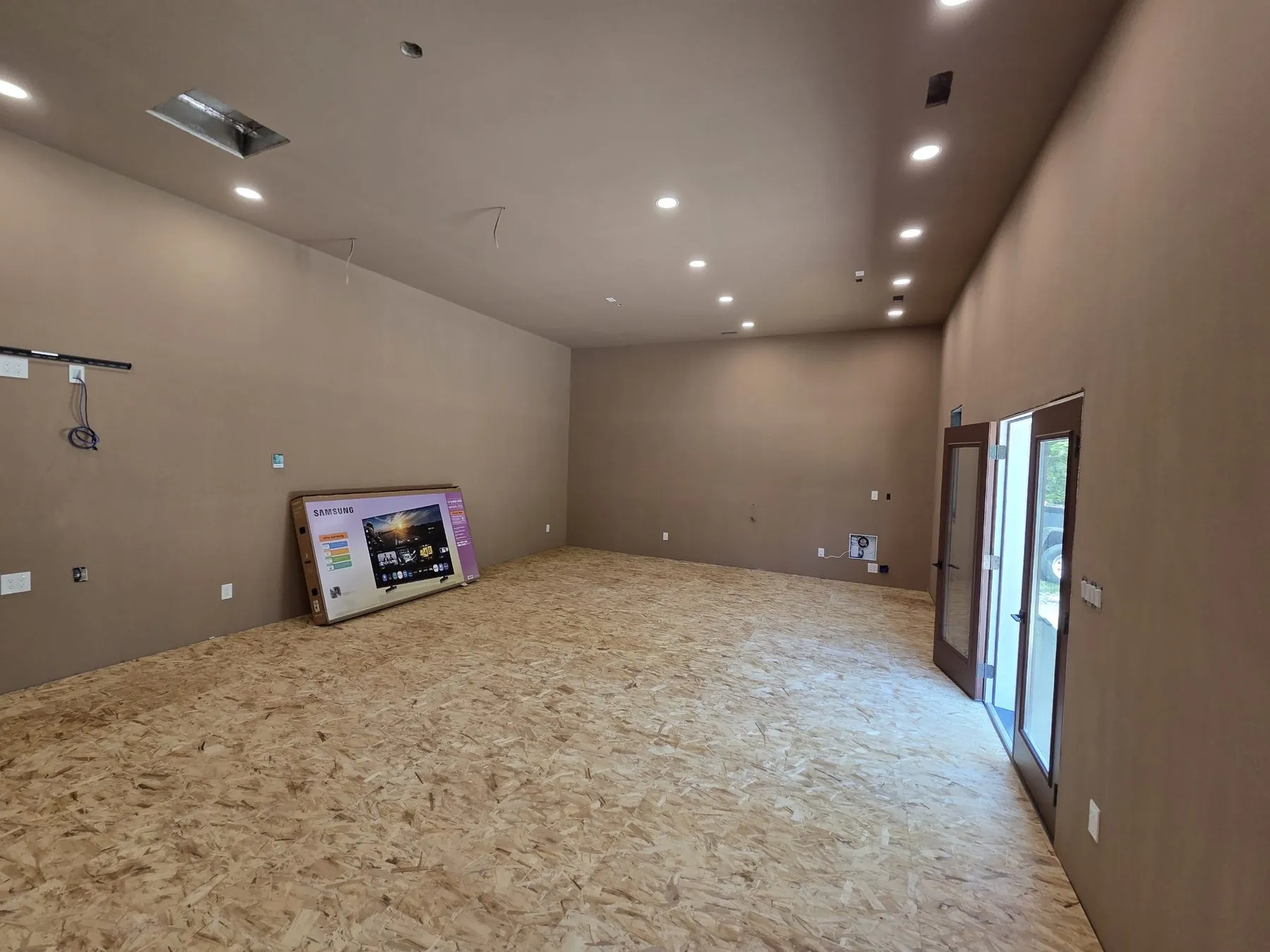 Finished walls and ceiling lighting inside the Giordano golf simulator building