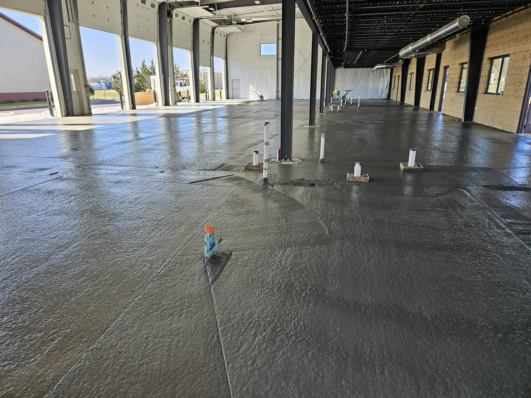 Commercial concrete floor placement underway inside the NEBA Realty building