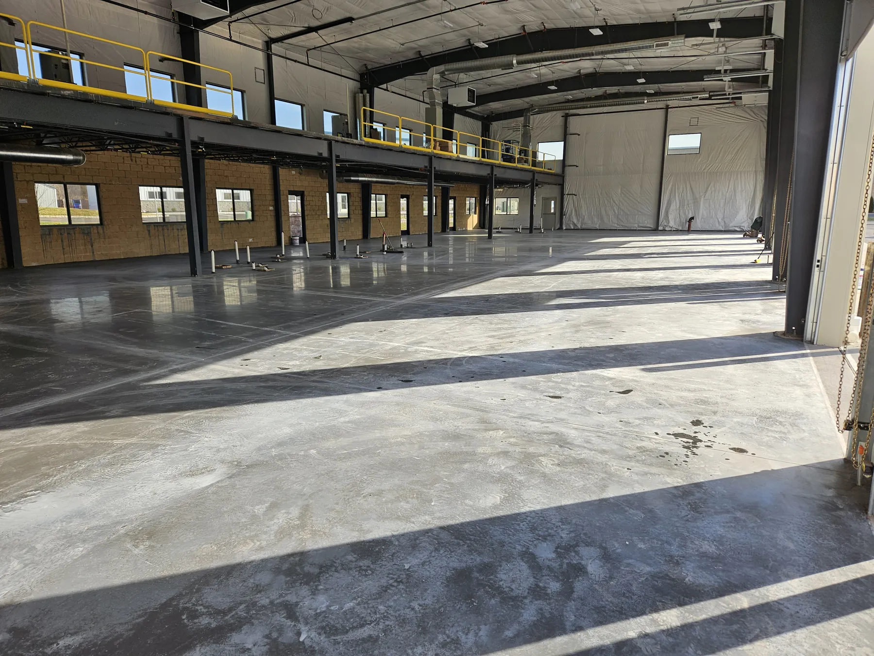 Finished commercial concrete slab beneath the mezzanine inside the NEBA Realty building