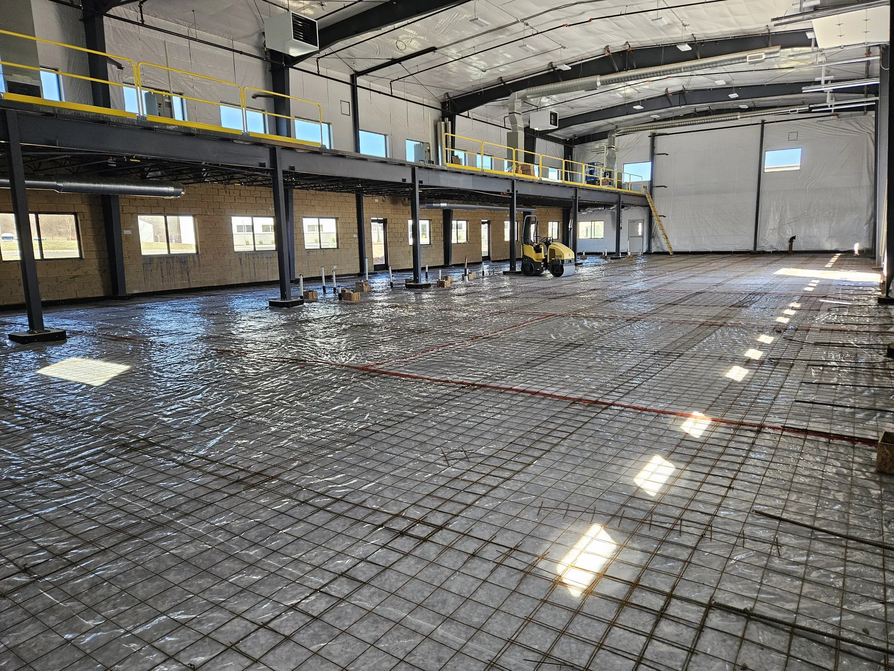 Mezzanine, reinforcing steel, vapor barrier, and slab preparation inside the NEBA Realty building